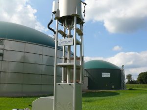 Biogas flare in front of stainless-steel digesters. Photo: Weltec.